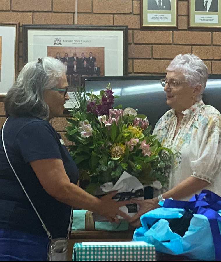 Gayle handing flowers to Dr Zeeman