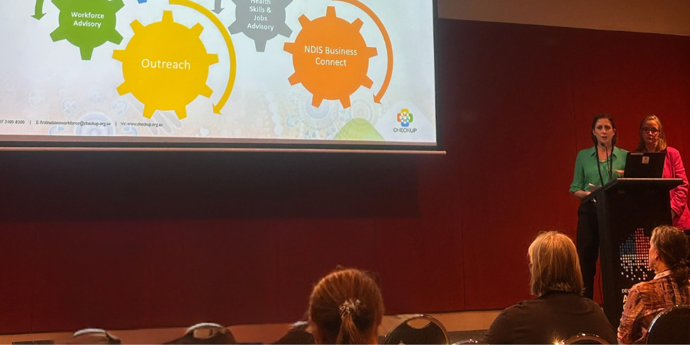 Carissa McAllister and Vicky Meyer presenting CheckUP's Workforce and Industry Development slide at DNAC